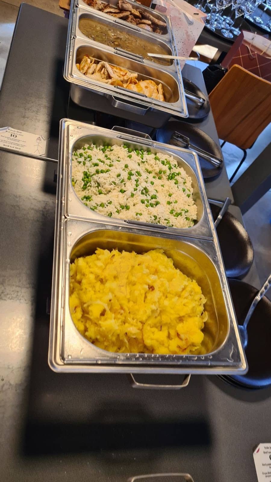 Close-up: trays of rice and potatoes on the buffet