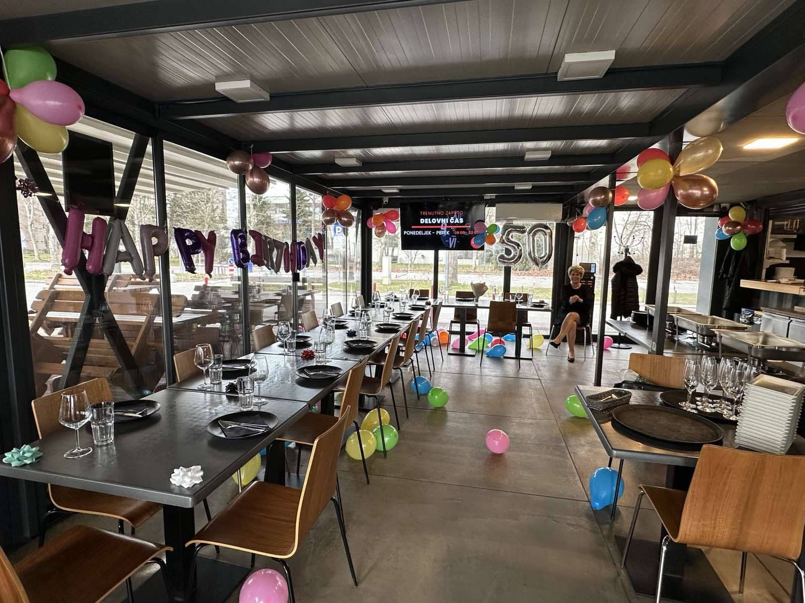 A long table with balloons, set for a birthday at Hotspot